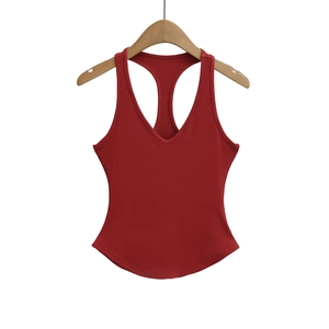 Detailed close-up of dark red ribbed knit texture and racerback design on a V-neck tank top