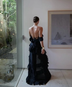 Detail of elegant black backless layered ruffle gown in lightweight flowing chiffon fabric