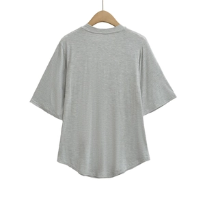 Detail view of heather gray short sleeve t-shirt with crew neck and curved hem design