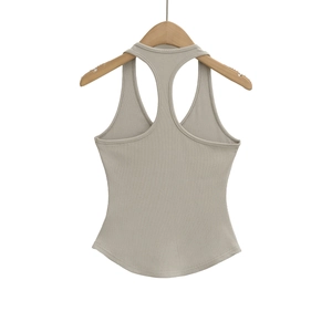 Detail shot of khaki ribbed tank top fabric texture on a wooden hanger