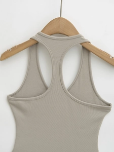 Detailed close-up of ribbed knit texture and racerback stitching on a khaki top