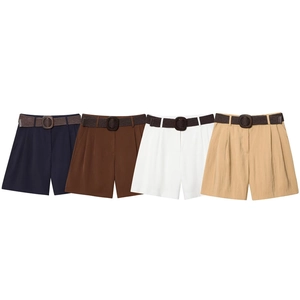 Flat lay of high-waisted pleated shorts in four colors with braided belts