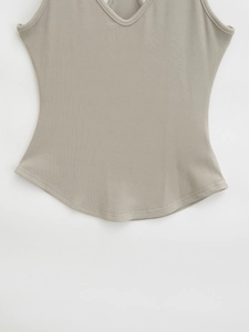 Close-up of the V-neckline and textured rib knit fabric on the khaki slim-fit top