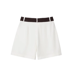 Detailed macro shot of white high-waisted shorts with a textured brown woven belt