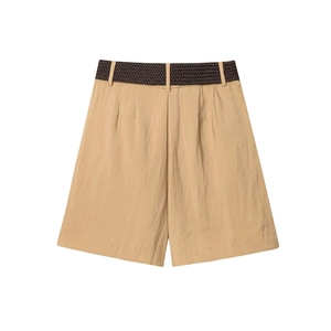 Close-up of khaki wide-leg shorts with a deep brown woven belt and pleated texture