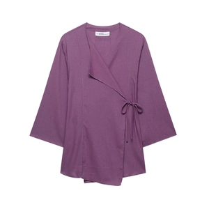 Detail view of purple side-tie top with V-neckline and fine woven texture detail