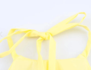 Detail of elegant lemon yellow halter neck tie with clean fabric texture and stitching