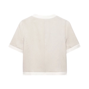 Detailed close-up of linen blend short-sleeved top showing high-quality fabric texture