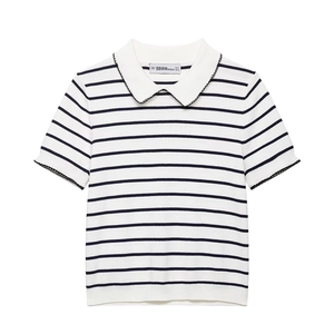 Close-up detail of knitted polo top showing scalloped Peter Pan collar and brand label