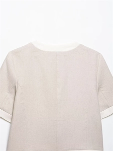 Close-up of beige linen blend short sleeve top with contrast white neckline detail
