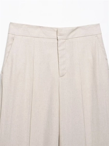 Detail of high-waist linen blend trousers with front pleats and side pockets in beige