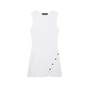 Detailed close-up of heart-shaped silver buckles and diagonal slit on white knit dress
