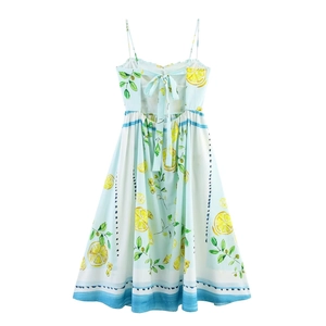 Detail of summer sundress featuring fresh lemon prints and a stylish back bow tie design