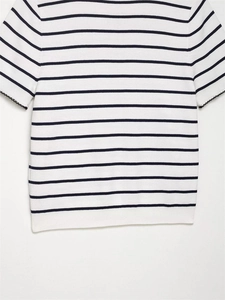 Detail of navy striped knit top featuring delicate black scalloped edges on the sleeve