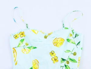 Detail of lemon print cotton poplin dress with ruffled neckline and thin spaghetti straps
