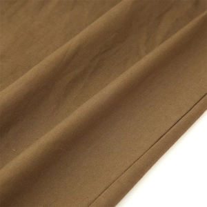 Detailed macro view of the premium linen blend fabric texture and professional stitching