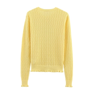 Pale yellow knit sweater for women with intricate diamond texture and ruffle hem detail