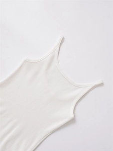 Close-up of white ribbed knit tank top showing fine fabric texture and thin straps