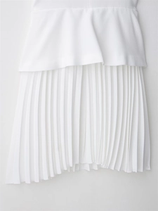 Detail of the white layered design featuring a pleated hemline on the elegant dress