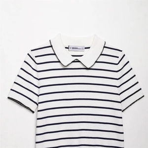 Women's white polo knit top with black stripes and scalloped lace trim detailing