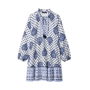 Detail of bohemian mini dress with blue paisley print and dark blue tassel drawstrings