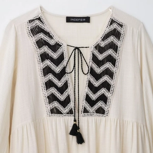 Bohemian cream V-neck embroidered top with black tassels and ethnic patterns