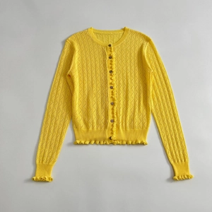 Women's bright yellow knit cardigan with diamond hollow texture and ruffle trim
