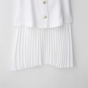 White mini dress with tailored blazer top, pleated skirt, and elegant gold buttons