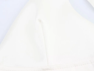 Macro shot of fine stitching and fabric detail on the white ribbon shoulder strap