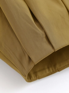 Close-up of khaki pilot jacket showing fine twill fabric texture and precise stitching detail