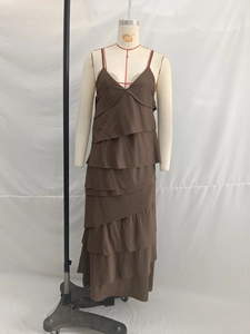 Detail view of dark brown tiered maxi dress featuring spaghetti straps and V-neckline