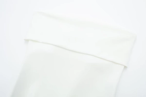 Close-up detail of the clean white ribbed knit collar and high-quality fabric texture
