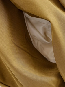 Detail of olive green bomber jacket fabric with smooth white inner lining texture