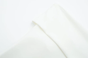 Detailed macro view of high-quality white fabric cuffs and textures on zipper top