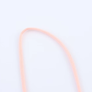 Close-up of peach woven tiered strap detailing on a 2025 spring midi dress