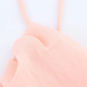 Pink tiered midi dress featuring spaghetti straps and refined cotton-linen texture
