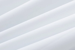 Close-up detail of white poplin midi dress fabric showing high-quality smooth texture