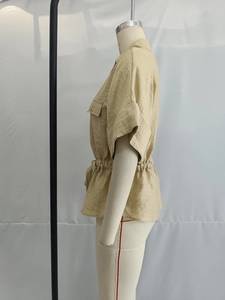 Detail of short sleeve khakhi shirt with lapel collar and elastic waist design