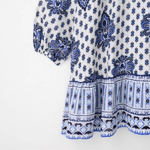 Detailed view of the bohemian floral pattern and ruffled hem on this mini dress