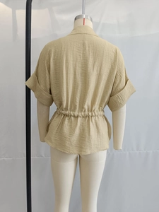 Detail of khaki short sleeve shirt with textured fabric and elastic pleated waist back