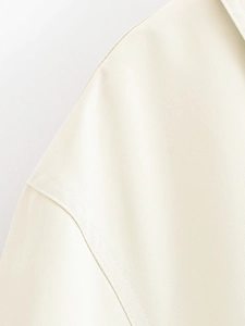 Detail of premium twill fabric shoulder with reinforced double stitching on beige jacket