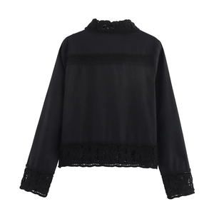 Detail of the black long sleeve blouse showing intricate crochet lace and back cutout