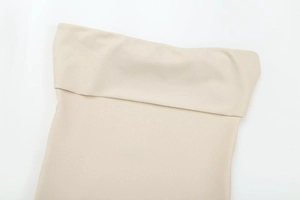 Detailed close-up of cream-colored pleated fabric texture on chic women zipper top