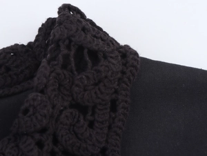 Macro view of black shirt crochet detailing and high-quality textured woven fabric