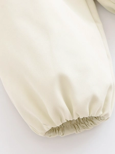 Detailed macro view of beige twill fabric texture and elastic ruched cuff design