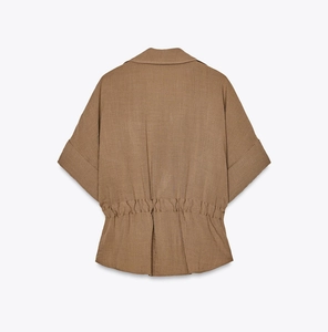 Back view of brown short-sleeve shirt with gathered elastic waist and linen texture