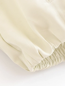 Detail shot of beige twill jacket showing elasticized cuffs and premium fabric texture