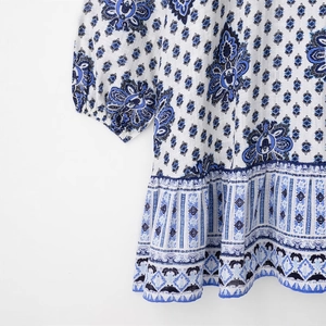Floral print mini dress with puff sleeves and ruffled hem in blue and white bohemian style