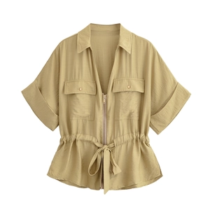 Detail of khaki short-sleeve shirt with utility pockets, zipper, and drawstring waist