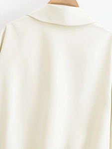 Close-up of the cream cotton twill jacket back featuring a sharp collar and smooth texture